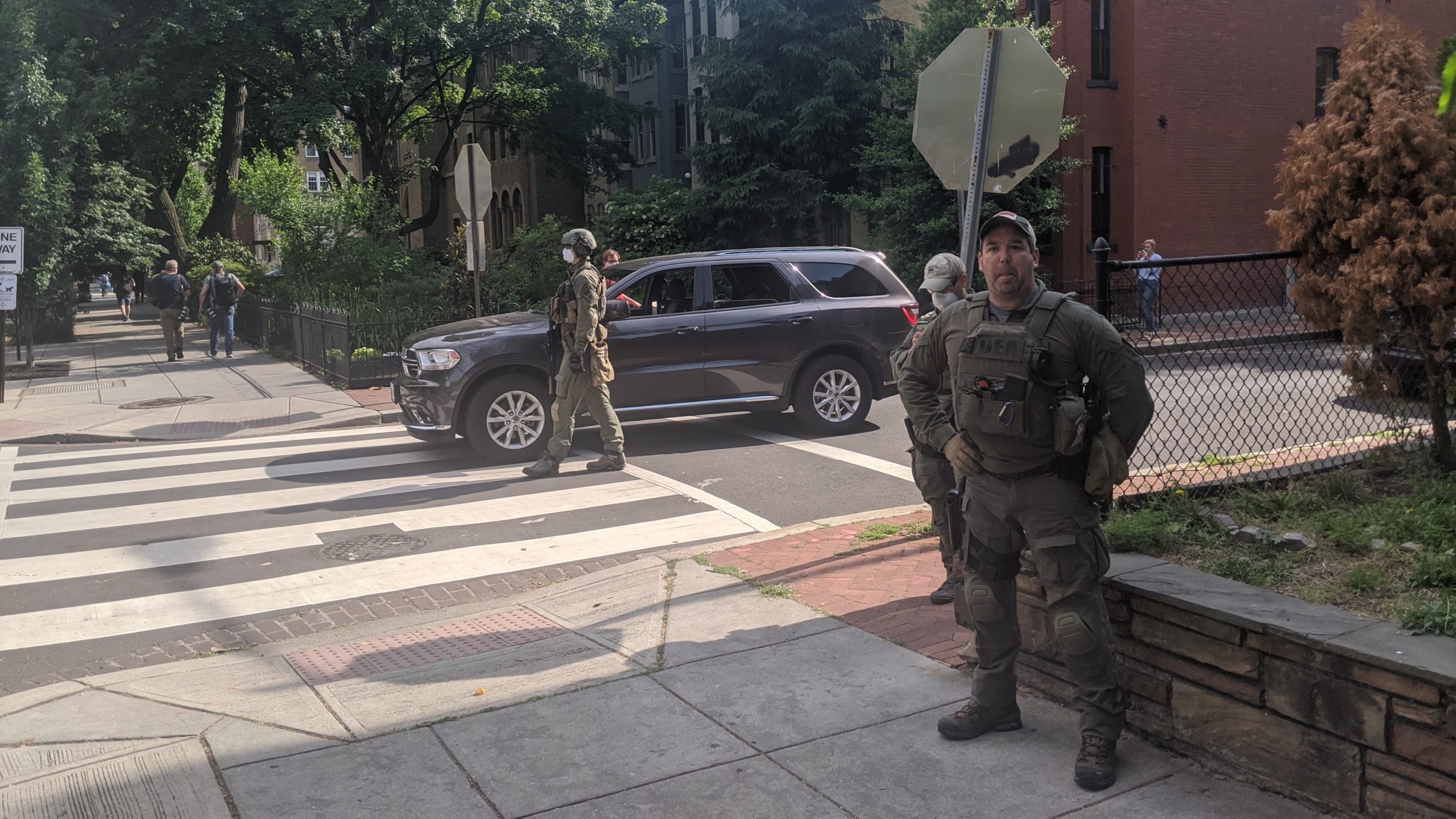 Federal agents with vests identifying them as Drug Enforcement Administration officers deployed in D.C. on June 2. (Photo: Tom McKay, Gizmodo)