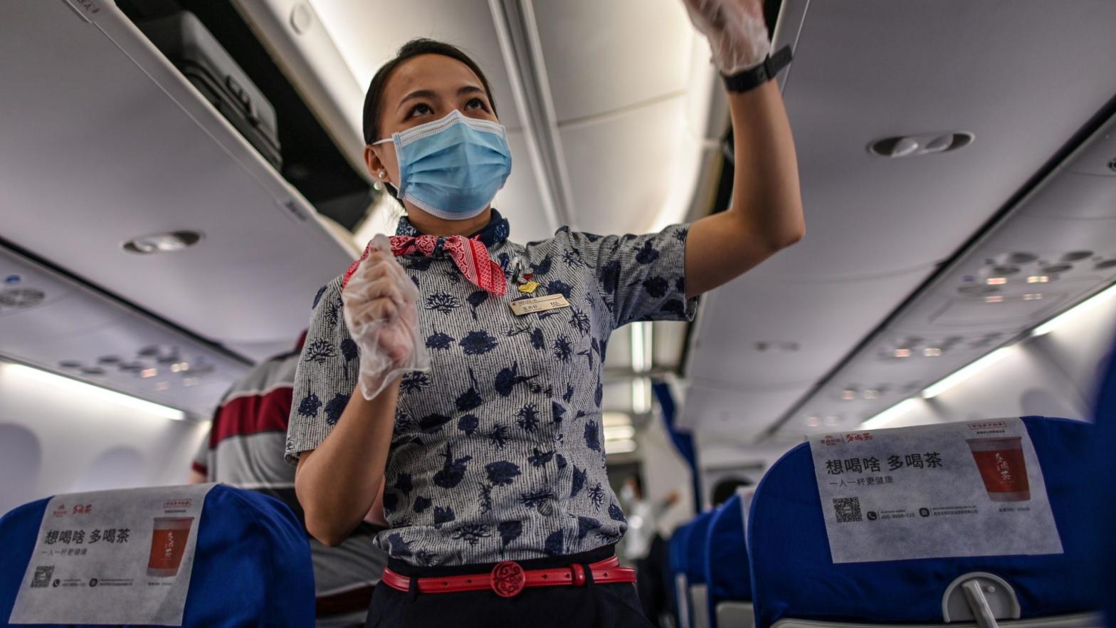 A flight attendant wearing a facemask on a flight to Shanghai at Tianhe Airport in Wuhan, in Chinas central Hubei province on May 29, 2020. (Photo: Getty Images)