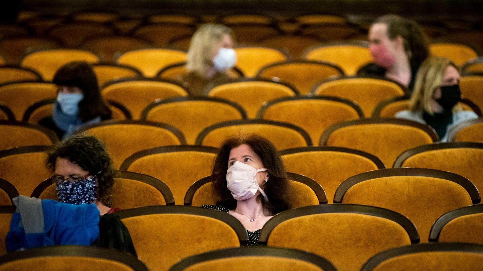 Customers wearing protective masks sit apart in observance of social distancing measures inside a movie theatre as the Czech government lifted more restrictions allowing cinemas to re-open on May 11, 2020, in Prague, Czech Republic. (Image: Getty)