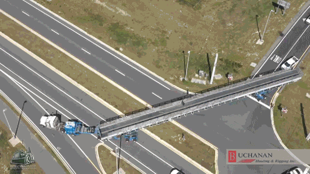 Watch This Truck Gracefully Maneuver A 152-Ton Trailer On A Two Lane Turn Pike