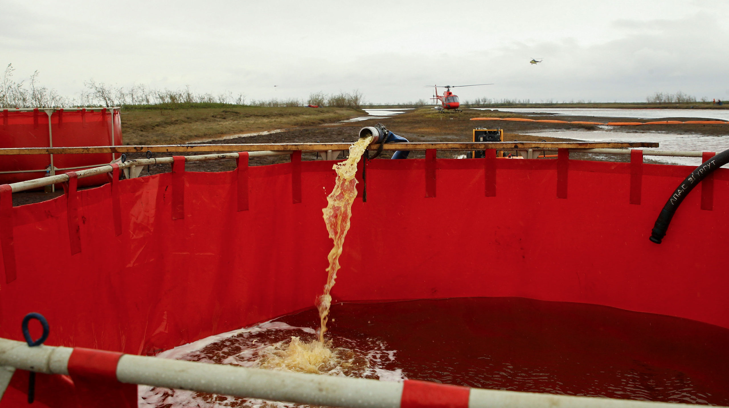 Spilled diesel fuel dredged from the river being poured into containment tanks.  (Image: Getty)