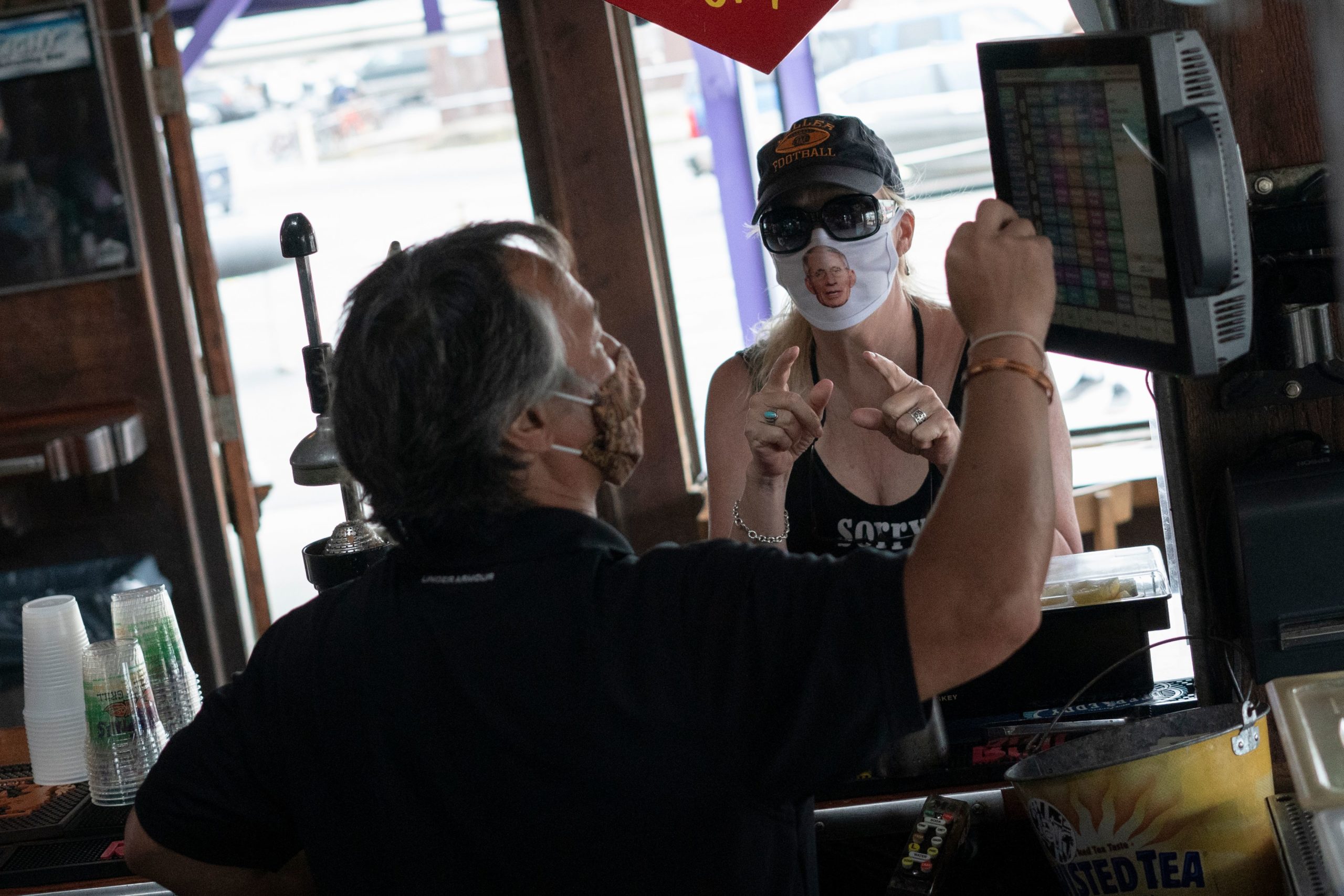 A restaurant guest wears a facemask with Dr. Anthony Fauci, director of the National Institute of Allergy and Infectious Diseases, as Fish Tails bar and grill opens for in-person dining, amid the coronavirus pandemic, on May 29, 2020 in Ocean City, Maryland (Photo: Getty Images)