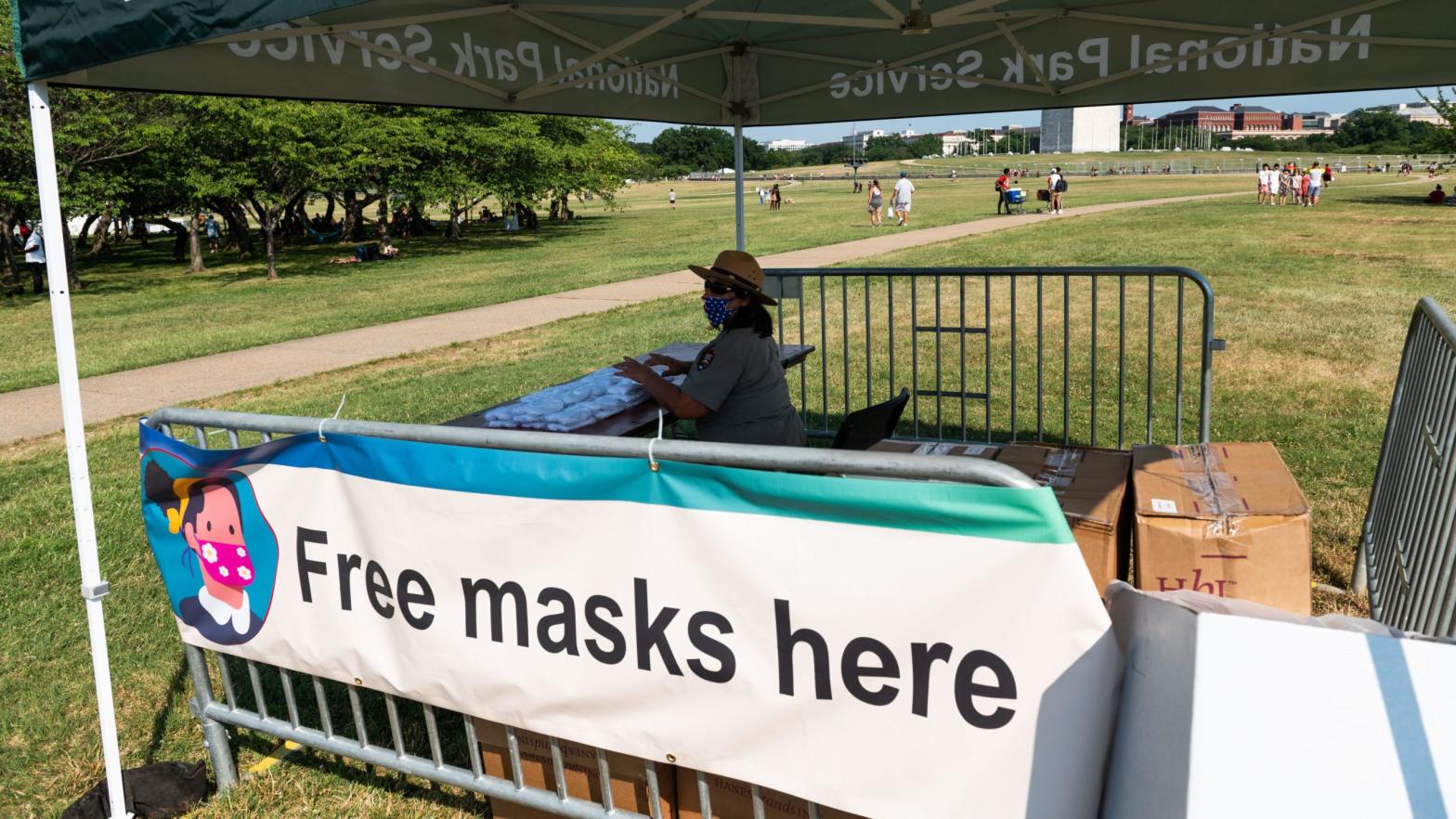 A U.S. Park Service Ranger preparing to distribute facemasks to people gathering near the Washington Memorial for Independence Day fireworks in Washington, DC on July 4, 2020.  (Photo: Roberto Schmidt, Getty Images)