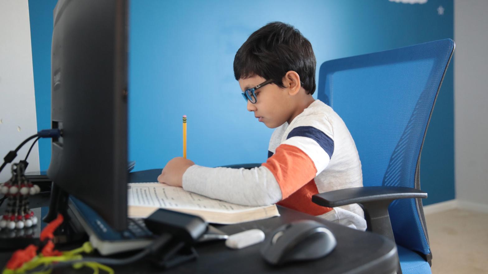Seven-year-old Hamza Haqqani, a second-grade student at Al-Huda Academy, uses a computer to participate in an online class with his teacher and classmates while at his home on May 1 in Bartlett, Ill. (Photo: Scott Olson, Getty Images)