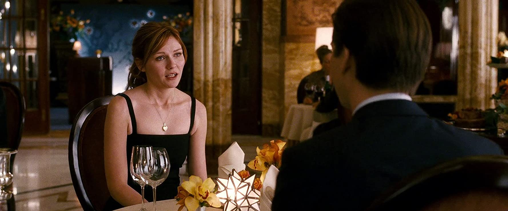 Peter and MJ's romantic dinner collapses before their eyes, but only one of them can see why. (Image: Sony Pictures)