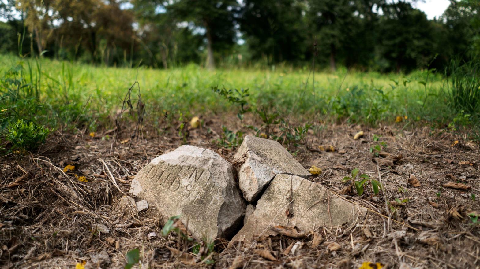 A broken gravestone lies in pieces in a slave graveyard on the Prairie View A&M University campus, a public historically black university, in Prairie View, Texas. (Photo: Melina Mara/The Washington Post via Getty Images, Getty Images)