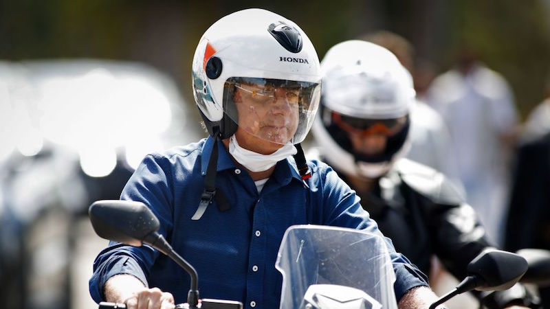 Brazilian President Jair Bolsonaro went for a motorcycle ride in Brasilia on Saturday after announcing that he had tested negative for covid-19. (Photo: Sergio Lima/AFP, Getty Images)