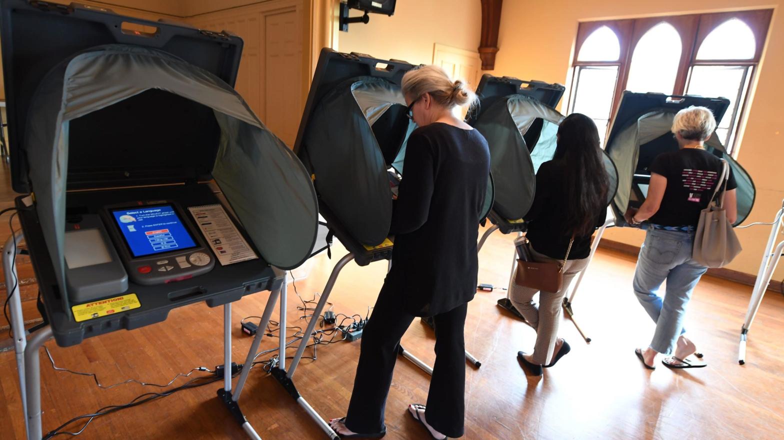 People use electronic voting machines to cast their ballot in the midterm elections at Neighbourhood Congregational Church in Laguna Beach, California on election day in 2018.  (Photo:  Robyn Beck, Getty Images)
