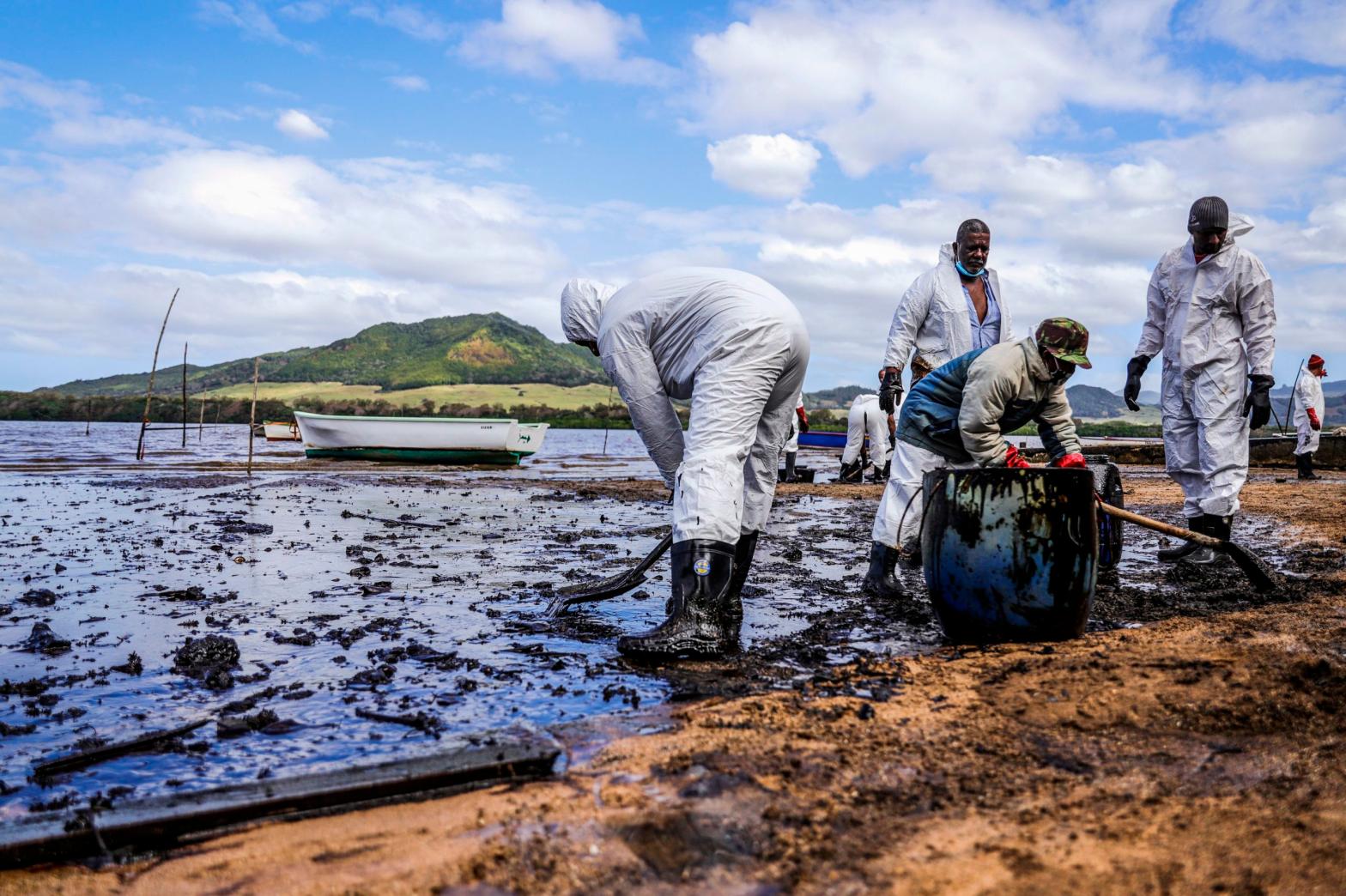 People scoop leaked oil near Blue bay Marine Park in southeast Mauritius on August 9, 2020 (Photo: L’Express Maurice, Getty Images)