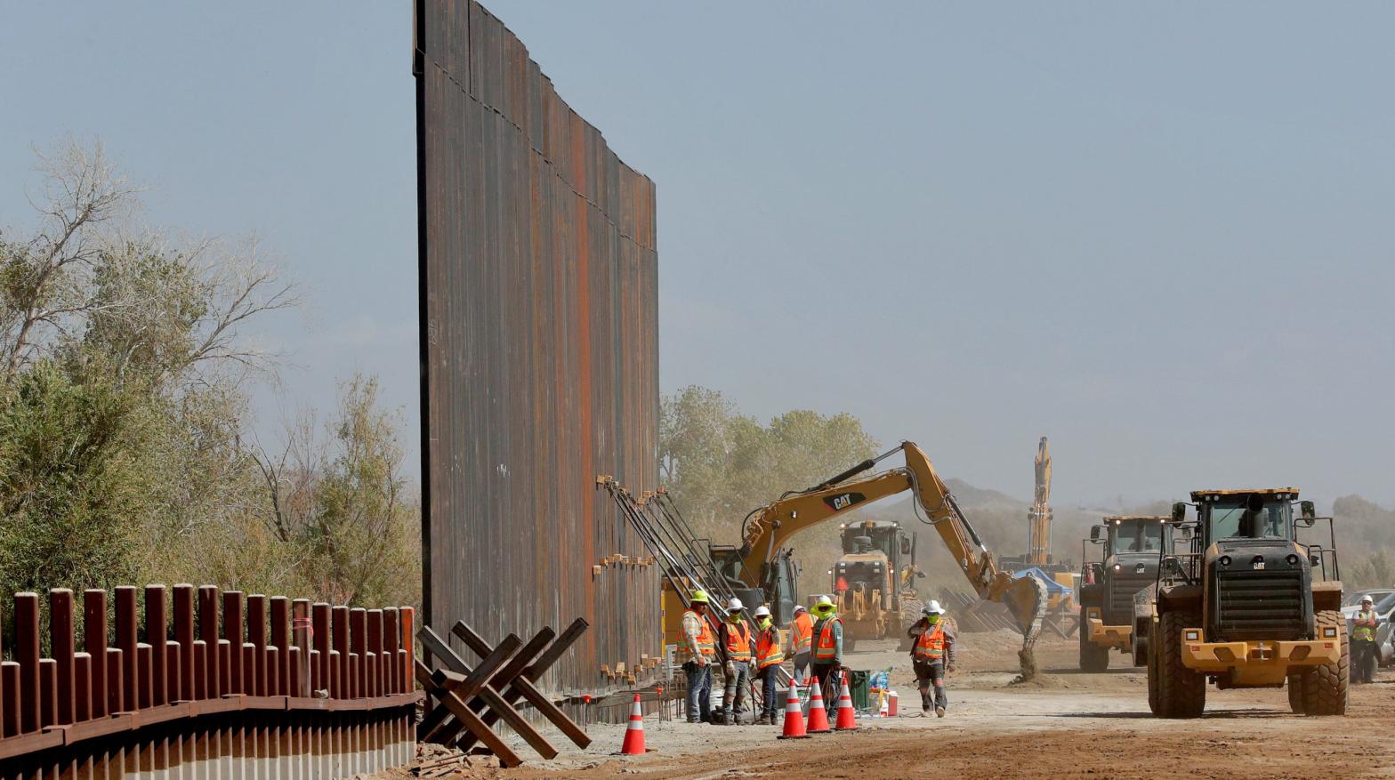 Government contractors erect a section of the border wall along the Colorado River in Yuma, Arizona, back in September 2019. (Photo: Matt York, AP)