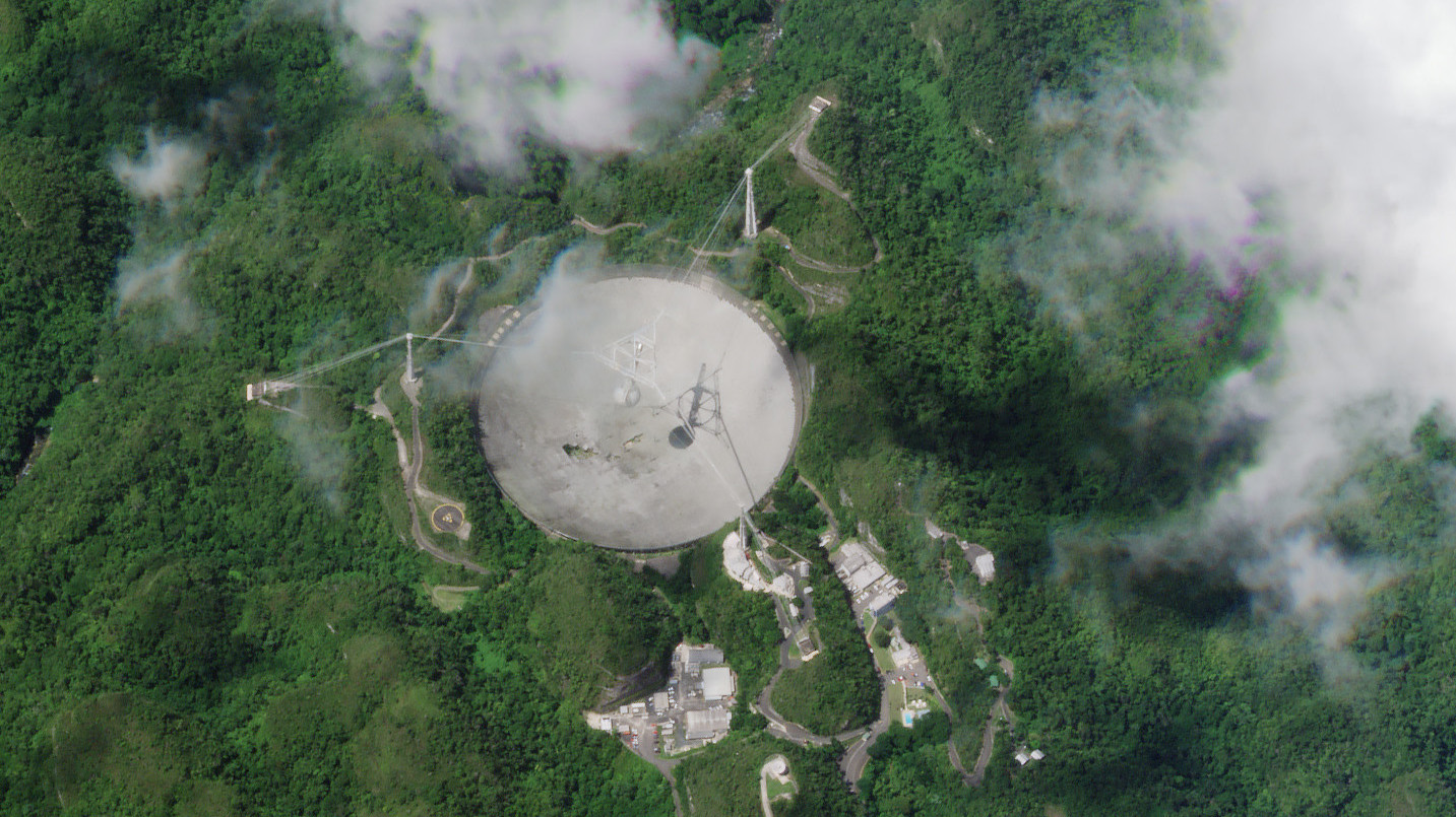 Viewed from space, the damage at the Arecibo Observatory doesn't seem so bad.  (Image: Planet Labs)