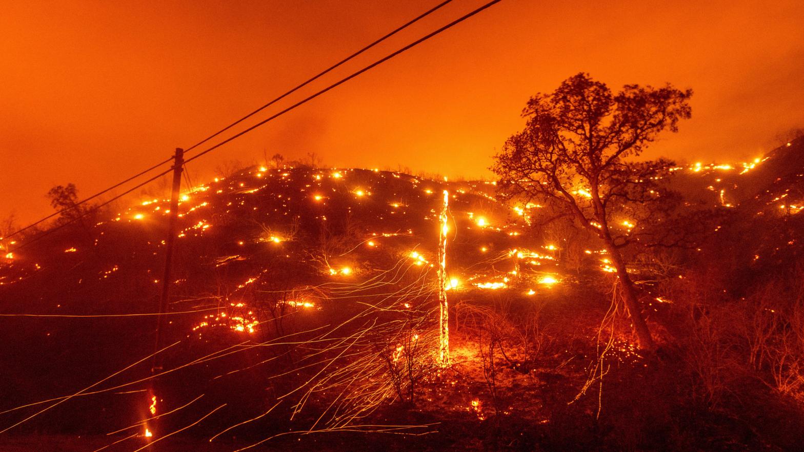 Seen in a long exposure photograph, embers burn along a hillside as the LNU Lightning Complex fires tear through Napa County on Tuesday, Aug. 18, 2020. (Photo: Noah Berger, AP)