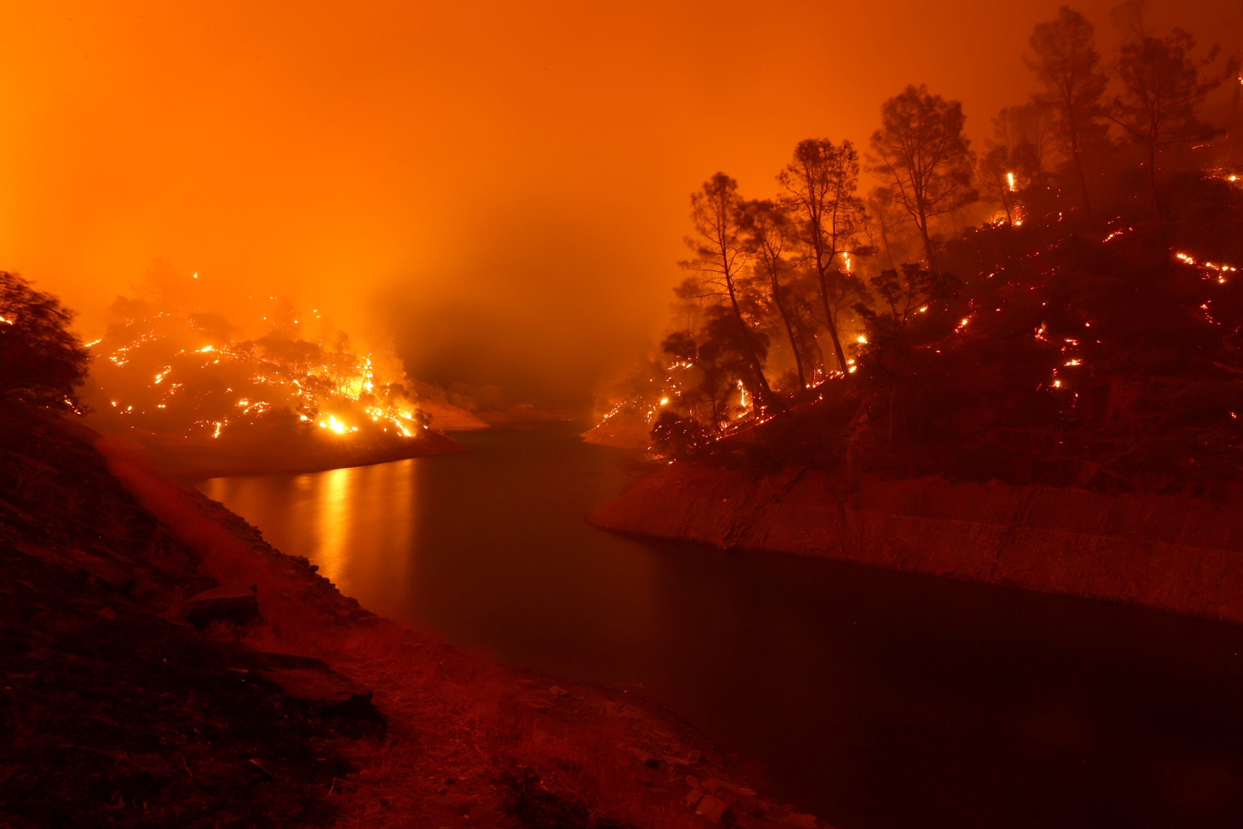 The banks around Lake Berryessa smolder after the LNU Lightning Complex Fire burned through the area on August 18, 2020 in Napa, California.  (Photo: Justin Sullivan, Getty Images)