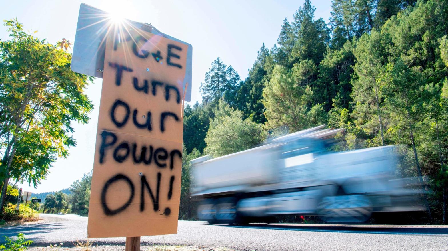 A sign calling for PG&E to turn the power back on is seen on the side of the road during a statewide blackout in Calistoga, California, on October, 10, 2019  (Photo: Josh Edelson , Getty Images)