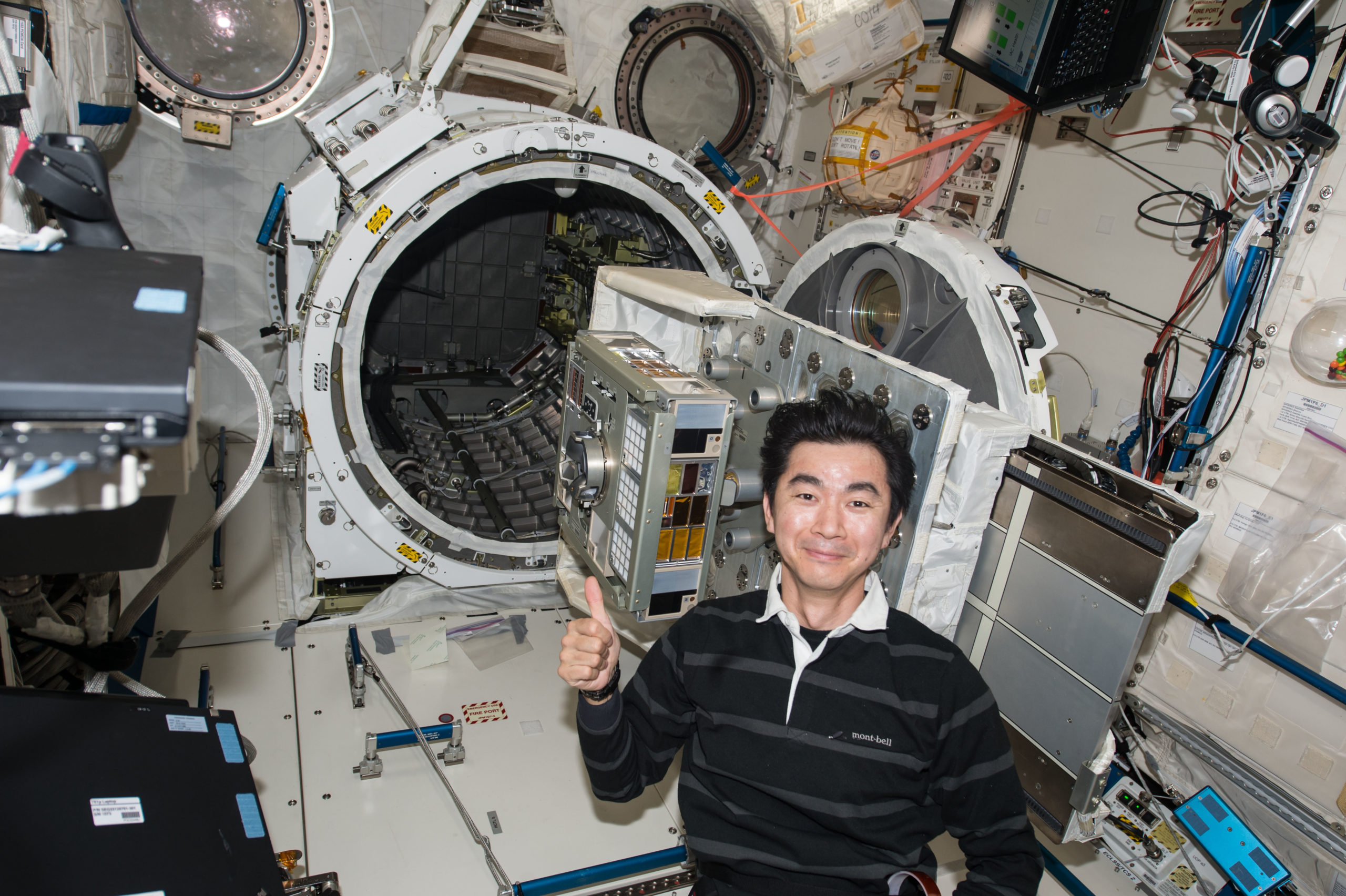 Japanese astronaut Kimiya Yui preparing the exposure experiment module.  (Image: JAXA/NASA)