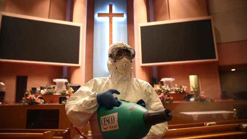 A disinfection worker wearing protective clothing sprays antiseptic solution in a Yoido Full Gospel Church amid concerns over the spread of coronavirus on August 21, 2020 in Seoul, South Korea. (Photo: Chung Sung-Jun, Getty Images)