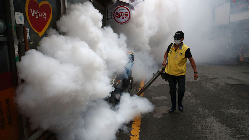 A worker disinfects an alley to prevent the spread of the coronavirus on August 29, 2020 in Seoul, South Korea. (Photo: Chung Sung-Jun, Getty Images)