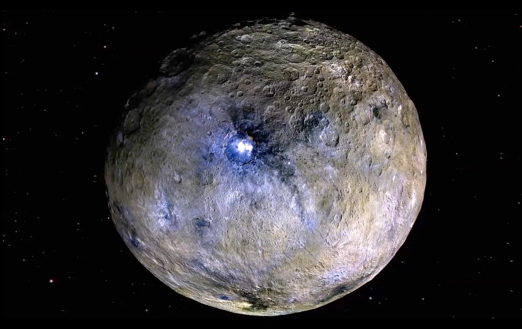 Dwarf planet Ceres shown in false colour, and its bright Occator Crater. (Image: NASA/JPL-CalTech/UCLA/MPS/DLR/IDA)