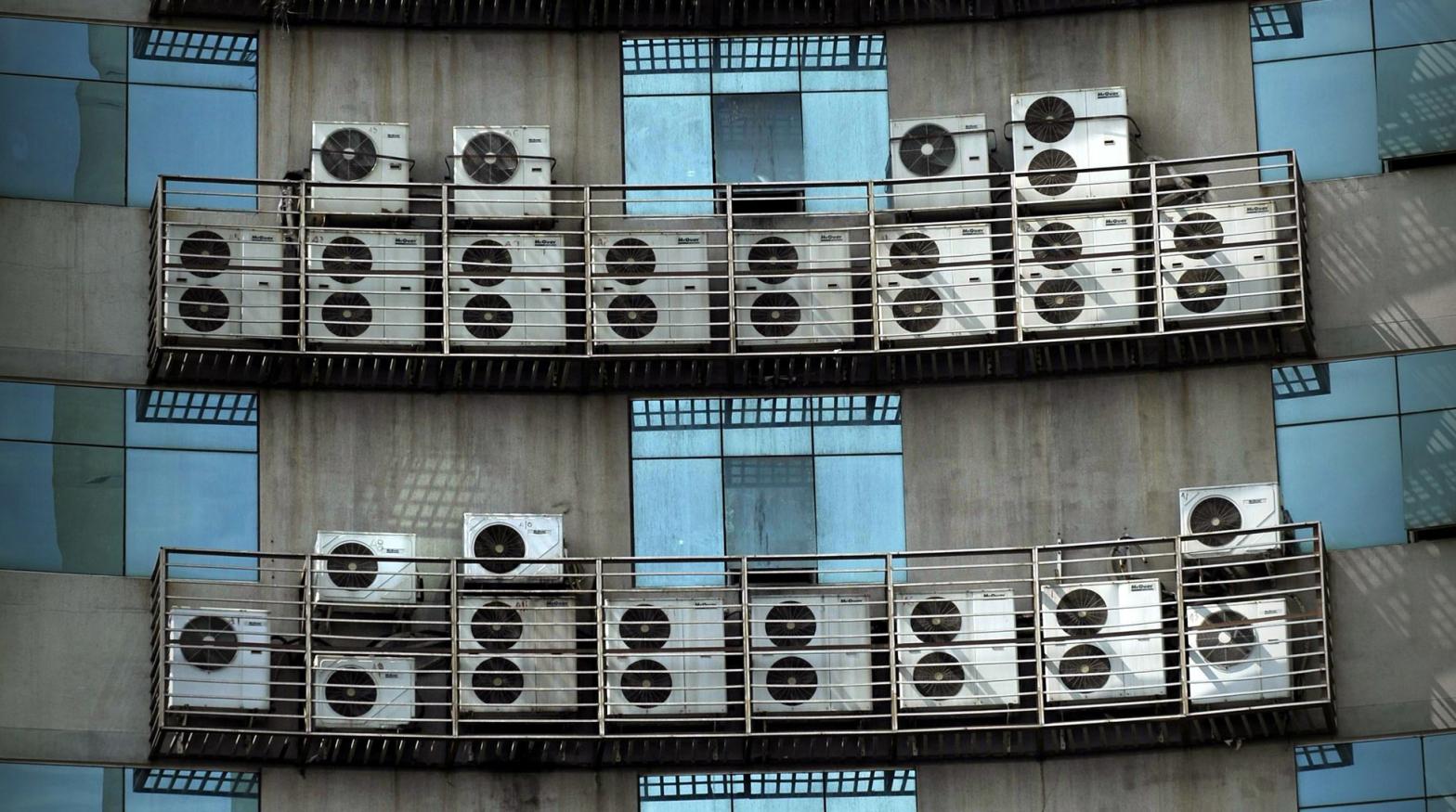Air conditioners hang on the wall of an office building in Fuzhou, China. (Photo: VCG, Getty Images)