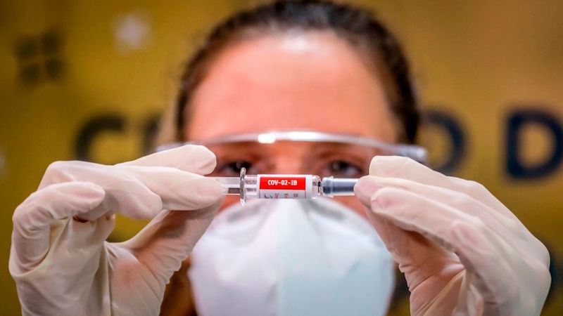 A nurse in Brazil holds a coronavirus vaccine candidate made by the Chinese company Sinovac Biotech. The trial for the vaccine is being carried out in Brazil. (Photo: Silvio Avila / AFP, Getty Images)