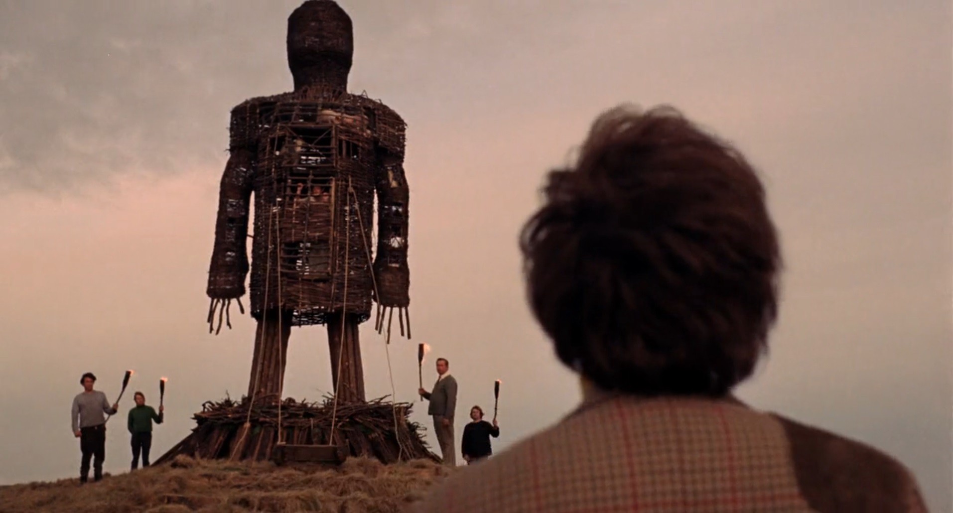 Looking over the titular Wicker Man. (Image: British Lion Films)