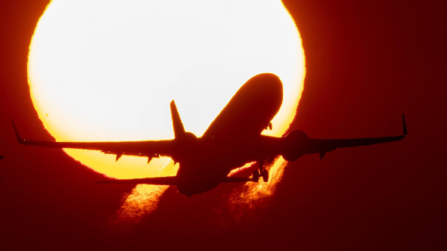 A plane in front of the sun. It's a metaphor. (Photo: AP, AP)