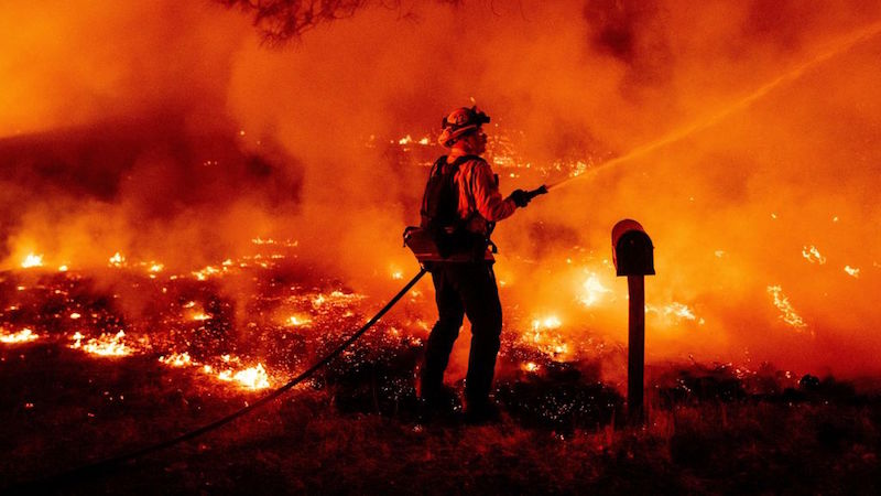 A Butte County firefighter douses flames at the Bear Fire in Oroville, California on September 9, 2020.  (Photo: Josh Edelson / AFP, Getty Images)