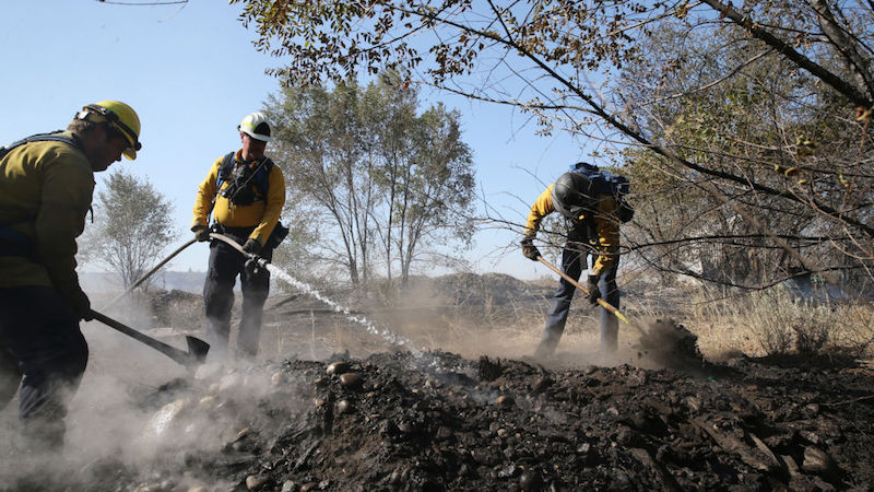 Firefighters Kyle Parker (L), Battalion Chief Bob Horst (C) and Sam Hochstatter from the Grant County Fire Department work to secure the fire line on the Cold Springs Fire on September 10, 2020 in Omak, Washington.  (Photo: Karen Ducey, Getty Images)