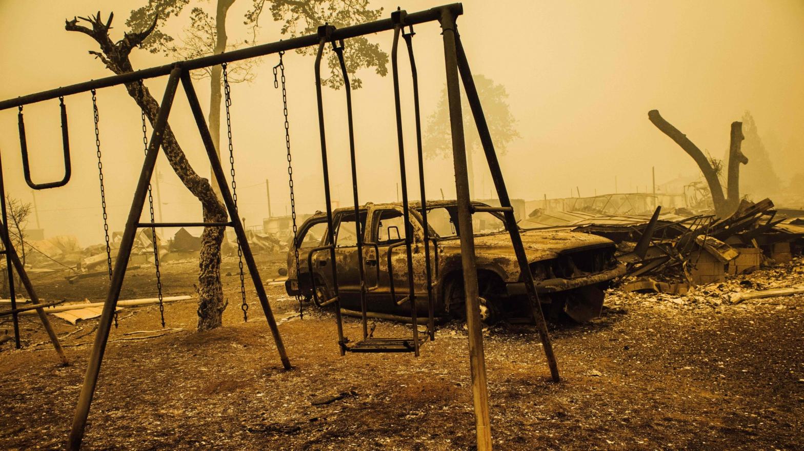 A charred swing set and car are seen after the passage of the Santiam Fire in Gates, Oregon, on September 10, 2020. (Photo: Kathryn Elsesser, Getty Images)