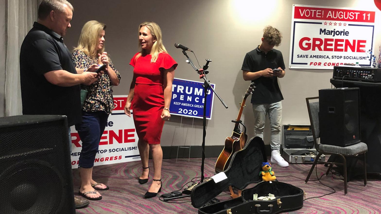 QAnon conspiracy theorist Marjorie Taylor Greene, seen in red, at an election event at Rome, Georgia in August 2020. (Photo: Mike Stewart, AP)