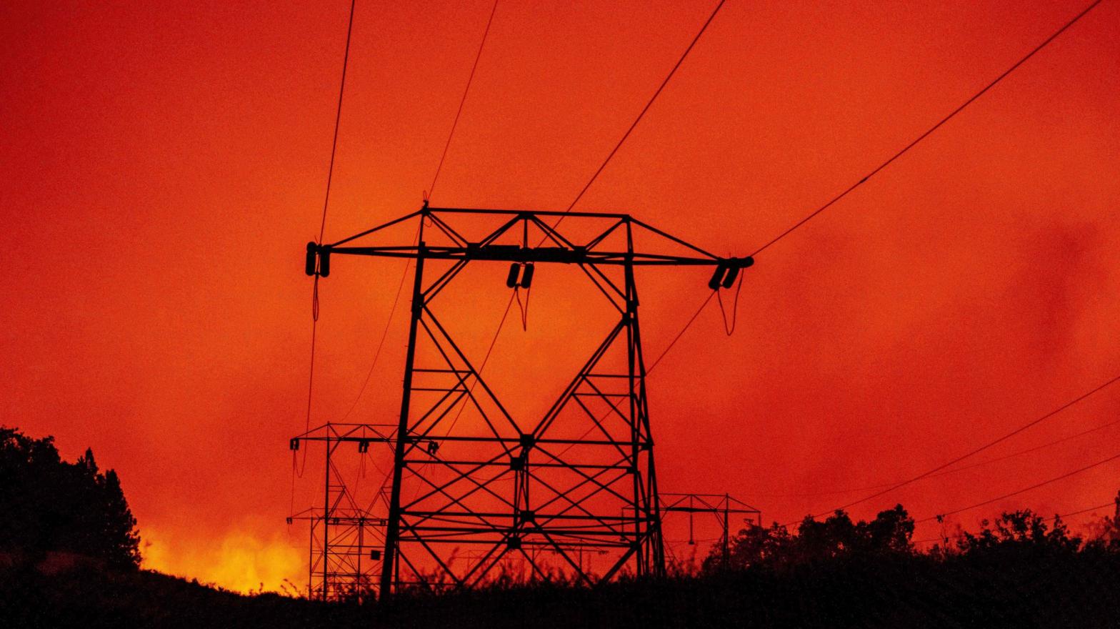 High-tension power lines are seen against a burning landscape during the Creek Fire in Fresno County, California. (Photo: Josh Edelson , Getty Images)