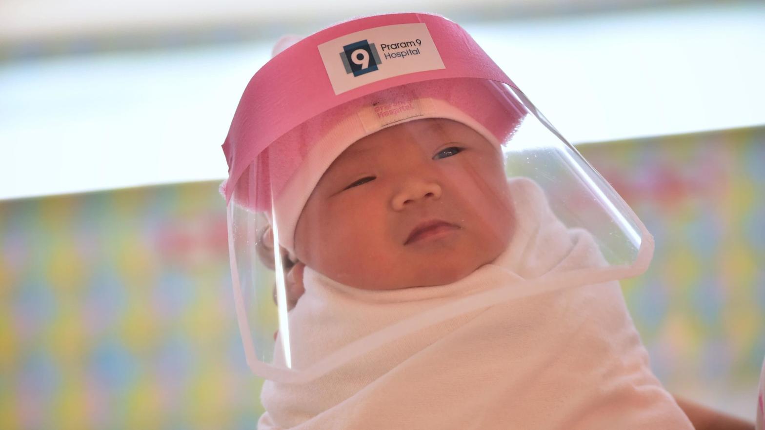 A photo of a newborn baby wearing a face shield, delivered at Praram 9 Hospital in Bangkok, Thailand on April 9, 2020.  (Photo: Lillian Suwanrumpha, Getty Images)