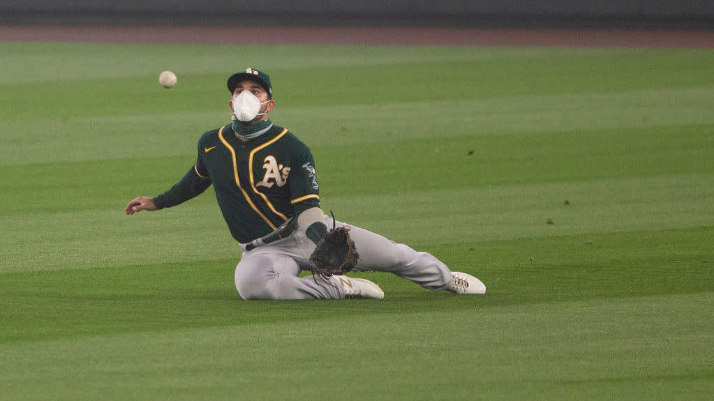 Ramon Laureano of the Oakland Athletics wears an N95-style mask as he catches a pop fly in the second inning of the first game of a doubleheader at T-Mobile Park on September 14, 2020, in Seattle, Washington.  (Photo: Lindsey Wasson, Getty Images)