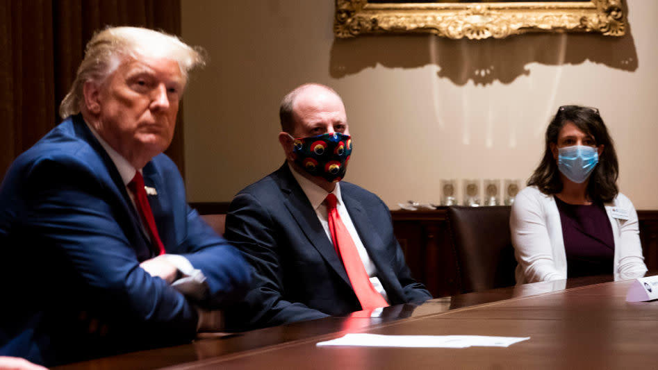 Colorado Governor Jared Polis (C) wears a face mask as U.S. President Donald Trump makes remarks during a meeting in the Cabinet Room of the White House, May 13, 2020. (Photo: Doug Mills-Pool, Getty Images)