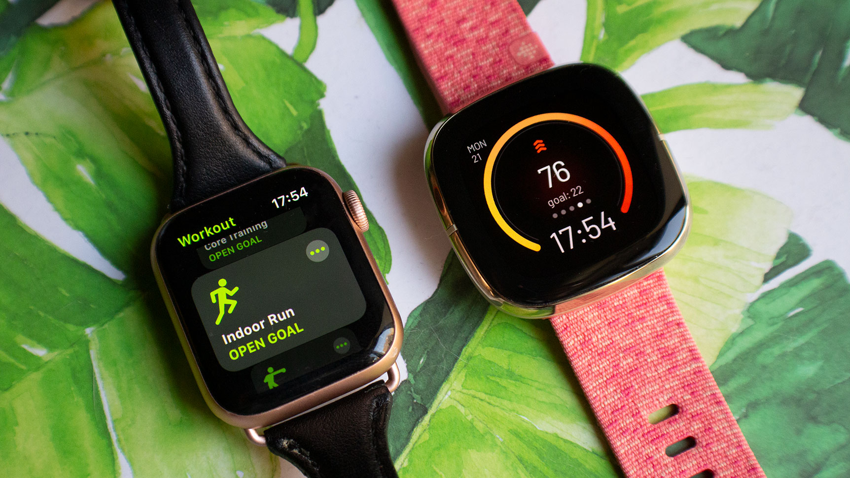 Apple Watch Series 5 on the left, the Fitbit Sense on the right. The designs are quite similar, though the Sense has a more squarish display.  (Photo: Victoria Song/Gizmodo)