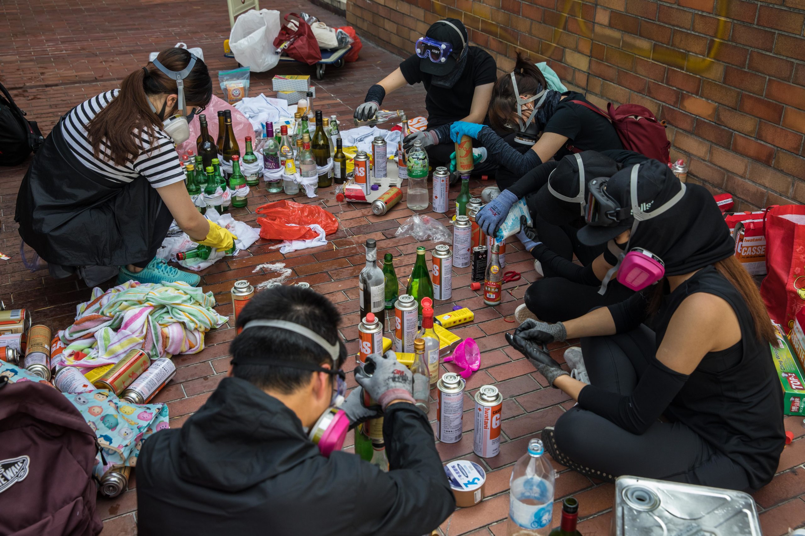 Pro-democracy protesters make molotov cocktails at the Hong Kong Polytechnic University, in Hong Kong on November 14, 2019.  (Photo: Dale De La Rey, Getty Images)