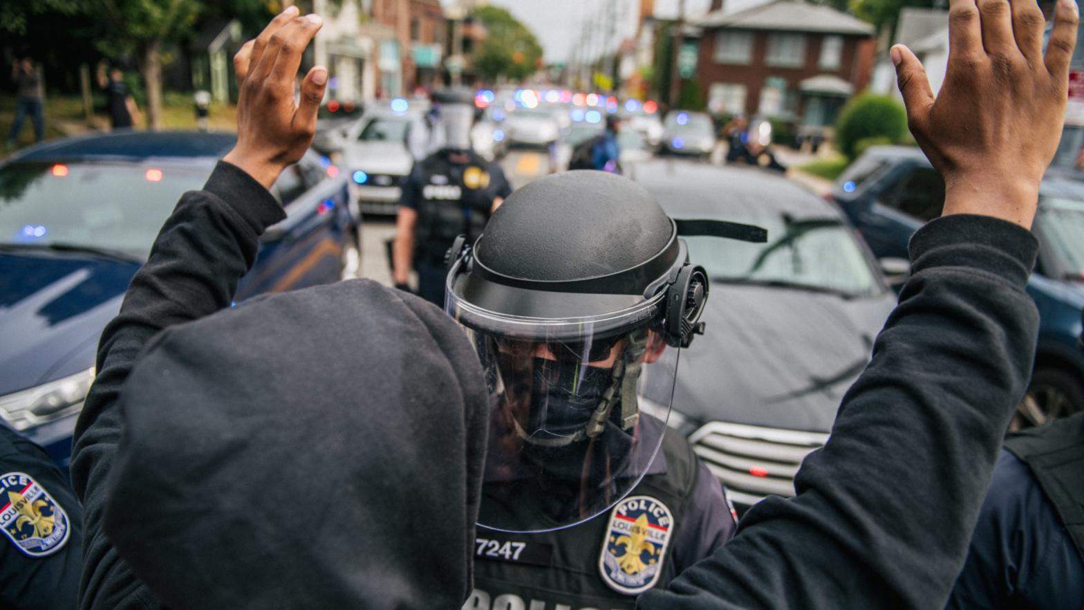A protester raises his hands in the air during a standoff with law enforcement on September 23, 2020, in Louisville, Kentucky. Protesters marched after a Kentucky Grand Jury indicted one of the three officers involved in the killing of Breonna Taylor with wanton endangerment. Taylor was fatally shot by Louisville Metro Police officers during a no-knock warrant at her apartment on March 13, 2020, in Louisville, Kentucky. (Photo: Brandon Bell , Getty Images)