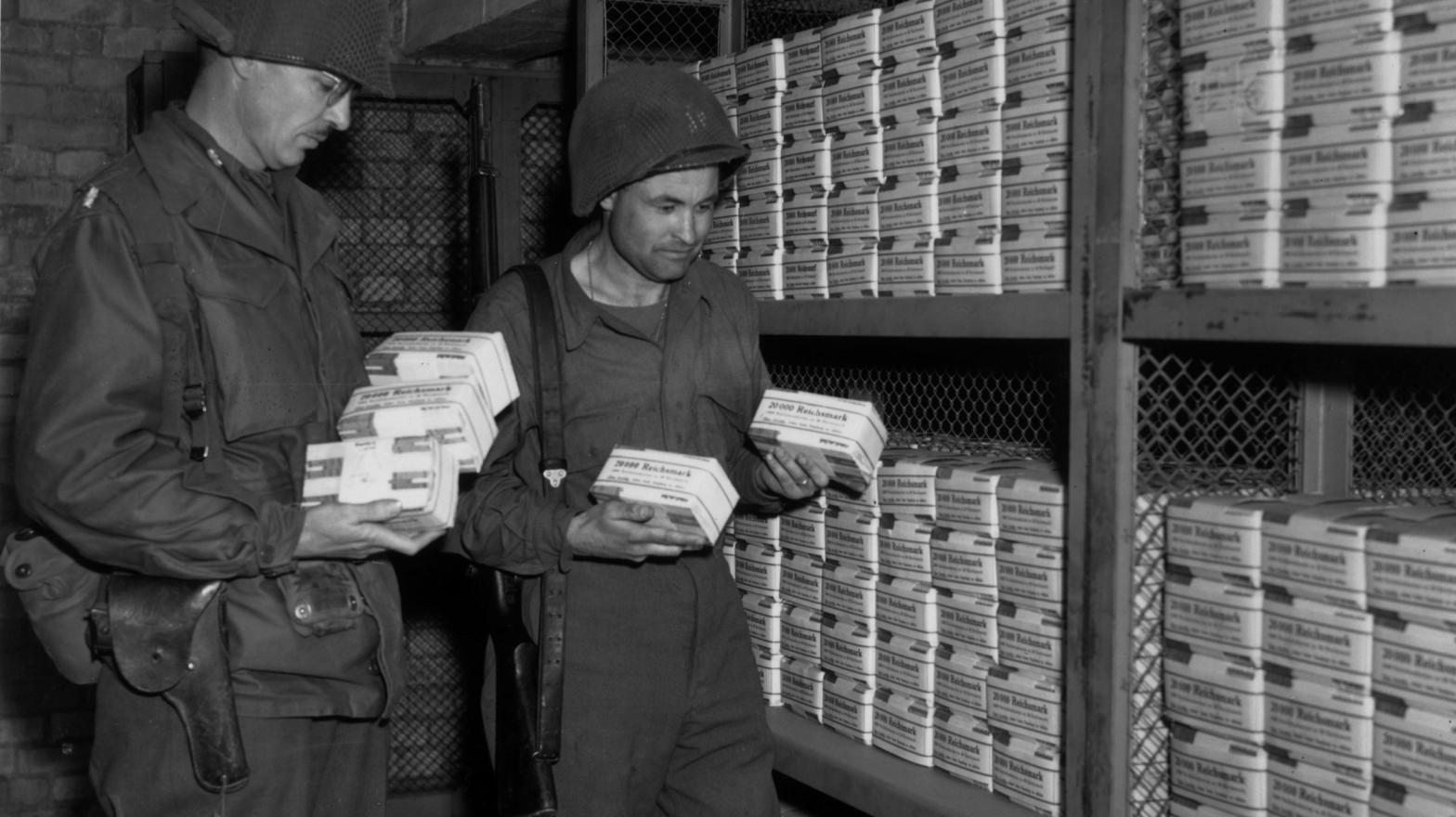 U.S. soldiers Lieutenant Colonel Ben T. Ammons (left) and Captain Virgil Happy in a bank in Magdeburg, Germany, where soldiers discovered 280 million dollars in Reichsmark notes on April 27, 1945. (Photo: Fred Ramage/Keystone, Getty Images)