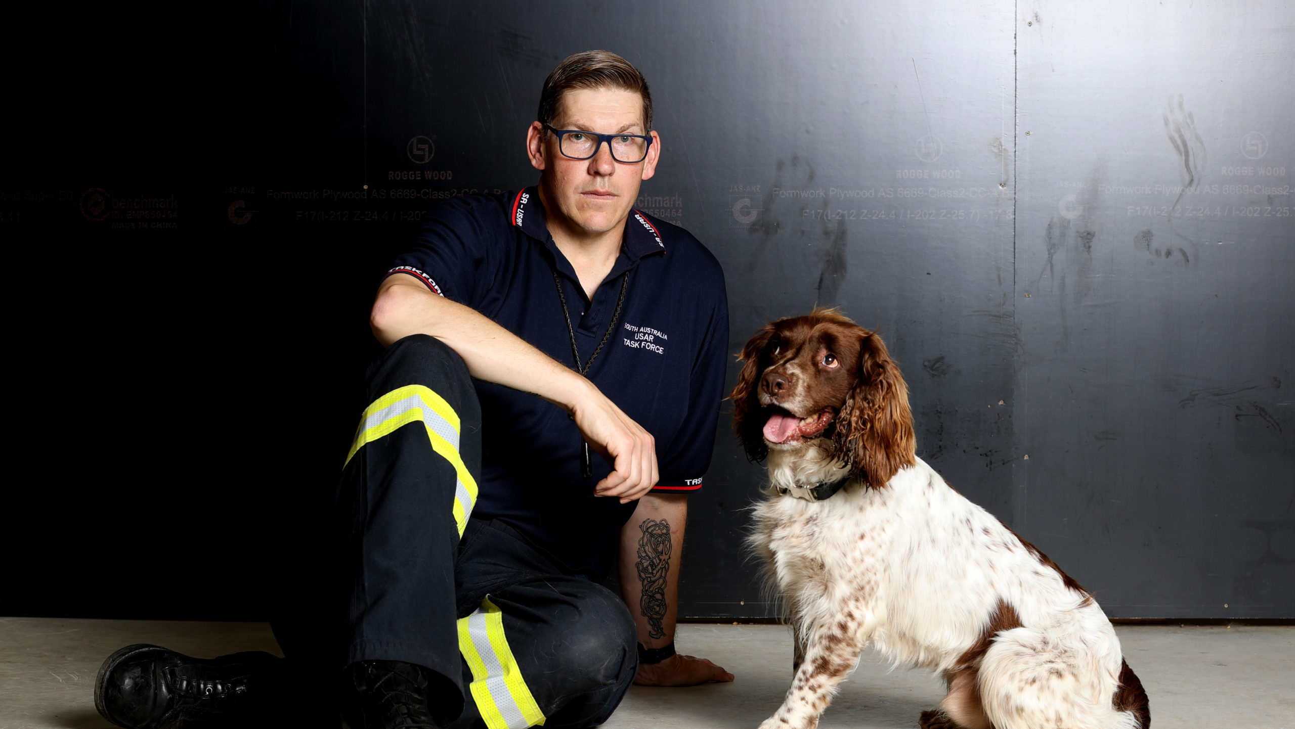 Dog handler and senior firefighter Alex Withers of the Metropolitan Fire Service SA and the SA Urban Search and Rescue Task Force with his English springer spaniel Floki. (Photo: Kelly Barnes, Getty Images)