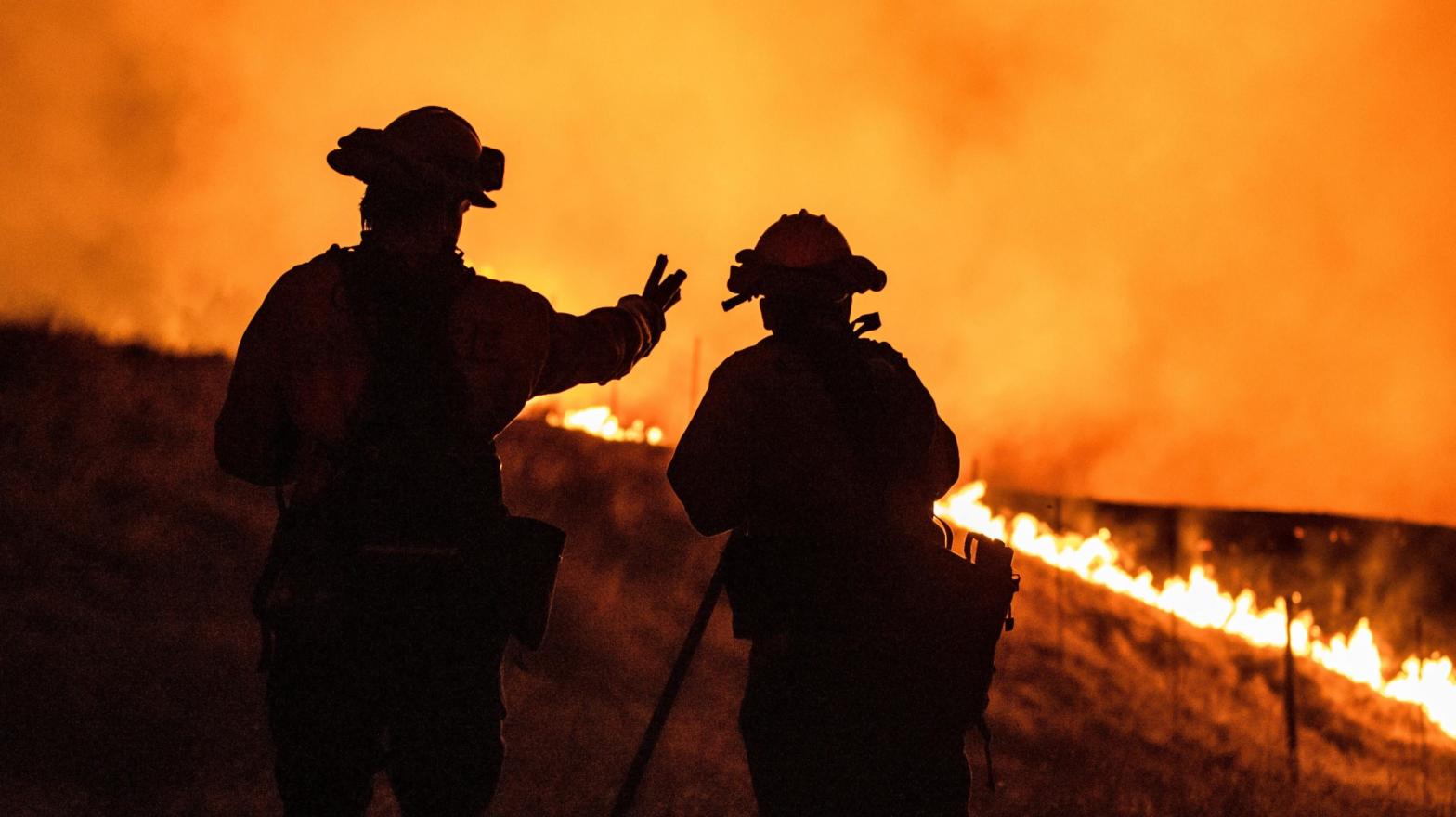 Fire fighters keep watching an approaching fire line on the outskirts of Santa Rosa, on September 27, 2020. (Photo: Samuel Corum, Getty Images)