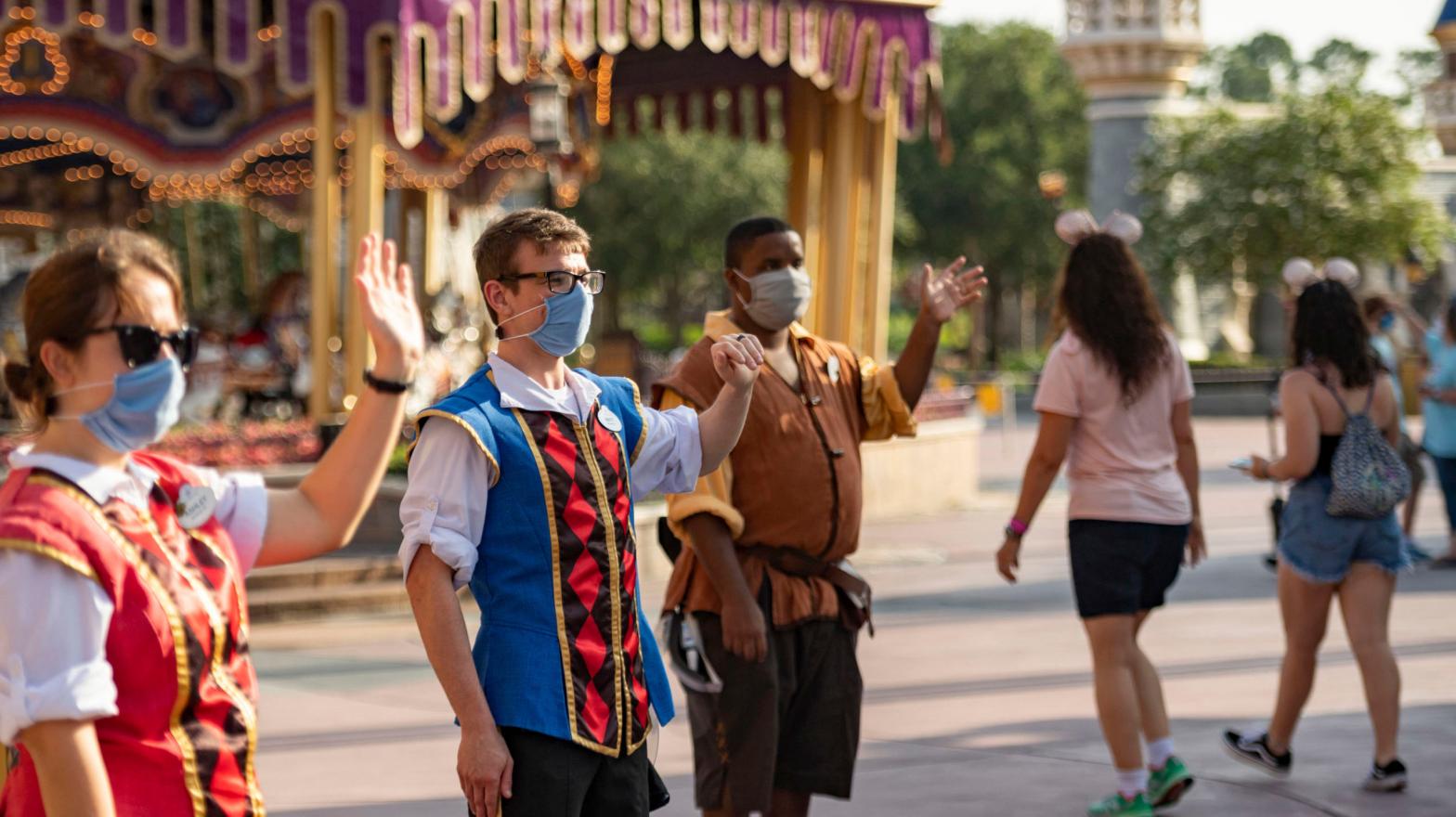 Masked Disney World employees welcoming guests back to the park on July 11.  (Photo: Matt Stroshane/Walt Disney World Resort, Getty Images)