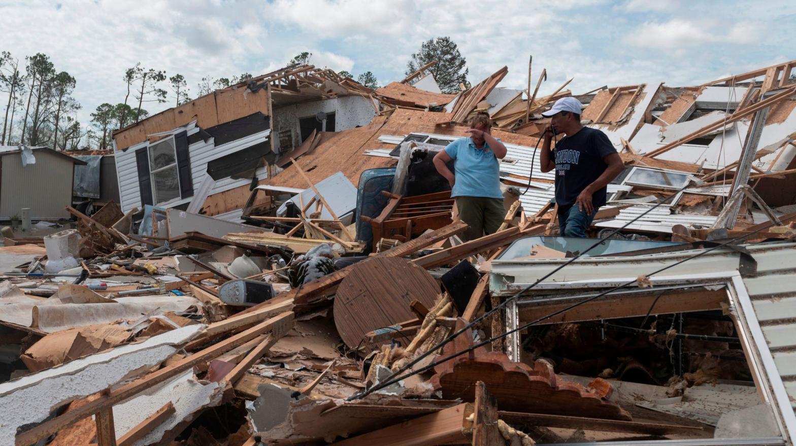 A couple react as they go through their destroyed mobile home following the passing of hurricane Laura in Lake Charles, Louisiana, on August 27, 2020. The same area is set to be hit by Hurricane Delta on Friday. (Photo: Andrew Caballero-Reynolds, Getty Images)