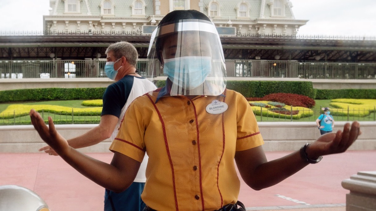 A Disney World cast member greets people during July 23's reopening. (Photo: Bryan R. Smith / AFP, Getty Images)