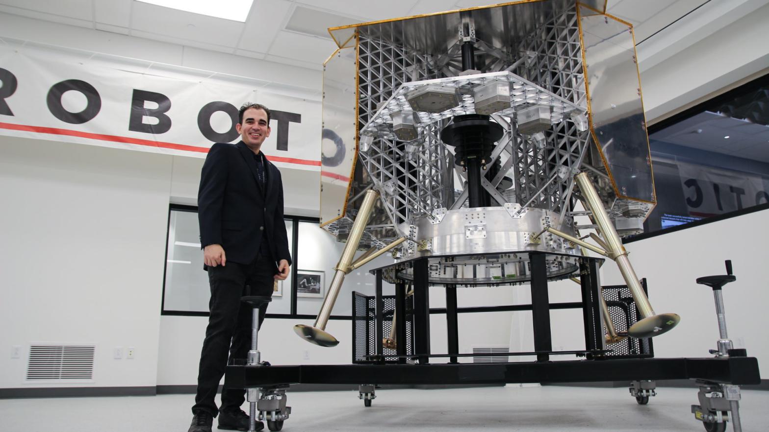 Astrobotic systems engineer Ander Solorzano stands beside a test model of the company's Peregrine lunar lander currently in development. It's set to be the first American lander on the Moon since the Apollo missions. (Photo: Astrobotic)