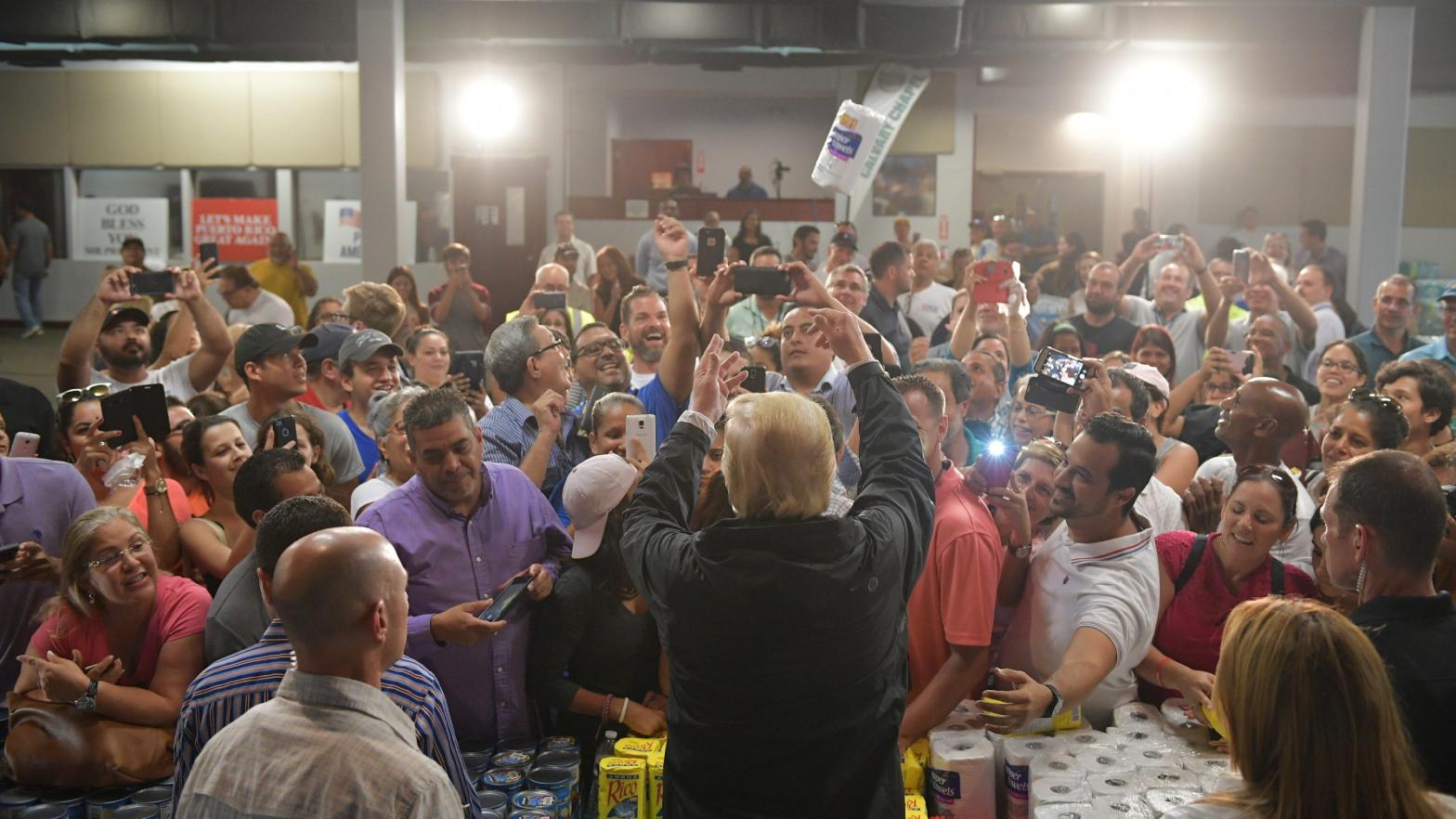 President Donald Trump takes part in a food and supply distribution at the Cavalry Chapel in Guaynabo, Puerto Rico on Oct. 3, 2017. Nearly two weeks after Hurricane Maria thrashed through the U.S. territory, much of the islands remains short of food and without access to power or drinking water. (Photo: Mandel Ngan/AFP, Getty Images)