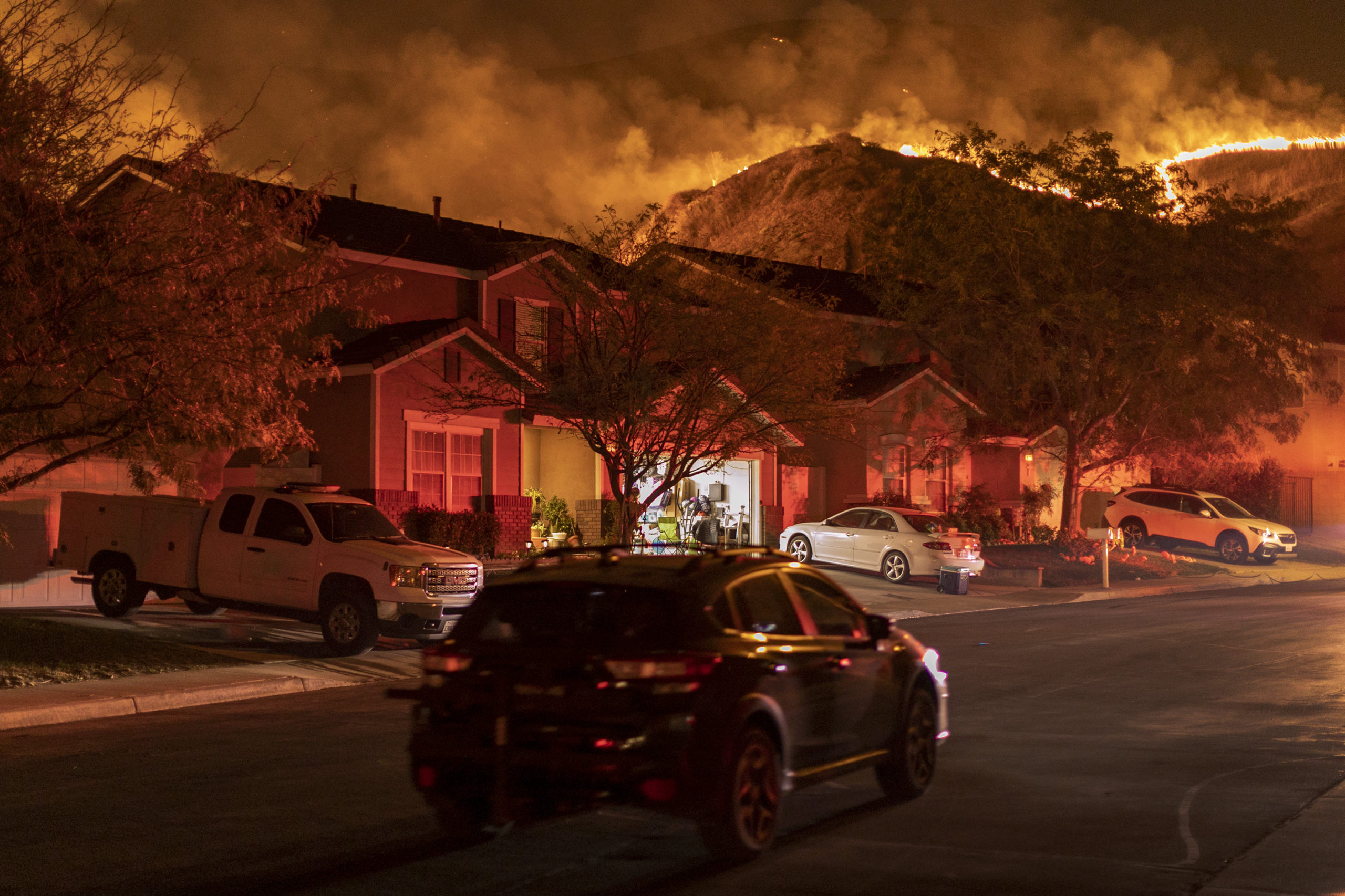 Flames come close to houses during the Blue Ridge Fire on Oct. 27, 2020 in Chino Hills, California. Strong Santa Ana Winds gusting to more than 145 km per hour have driven the Blue Ridge Fire and Silverado Fire across thousands of acres, grounding firefighting aircraft, forcing tens of thousands of people to flee and gravely injuring two firefighters. More than 8,200 wildfires have burned across a record 4 million-plus acres so far this year, more than double the previous record.  (Photo: David McNew, Getty Images)