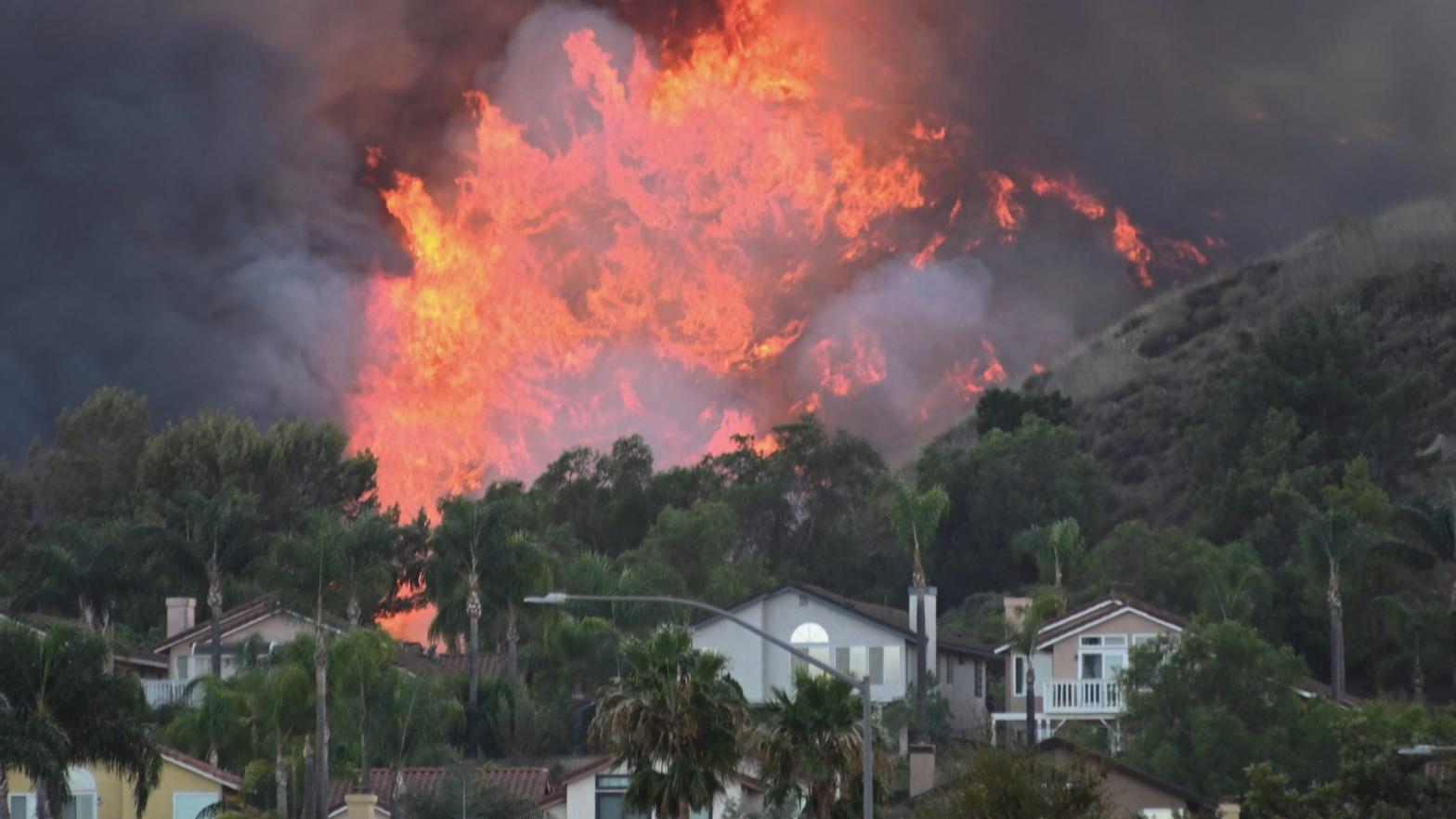 The Blue Ridge Fire burning near homes in Chino, California in late October. (Photo: Robyn Beck/AFP, Getty Images)