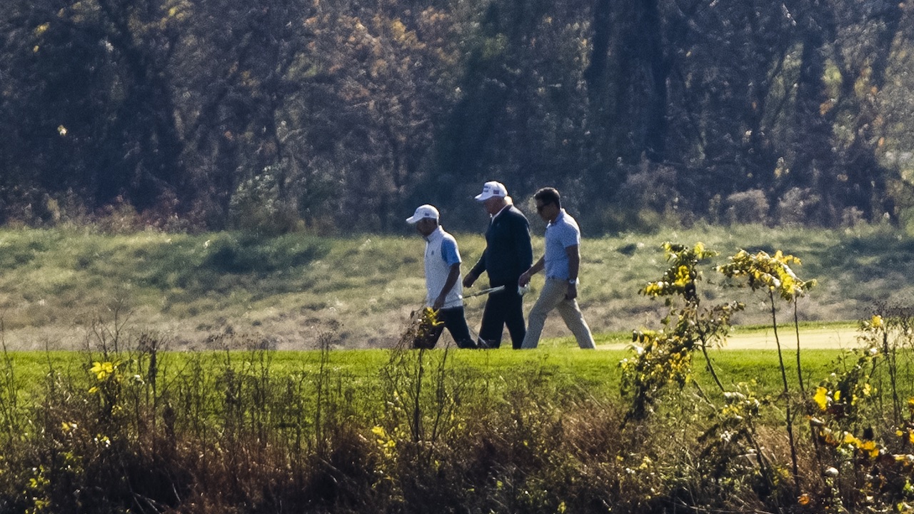 President Donald Trump (centre) plays golf at his private club, Trump National Golf Club on November 8, 2020 in Sterling, Virginia. (Photo: Samuel Corum, Getty Images)