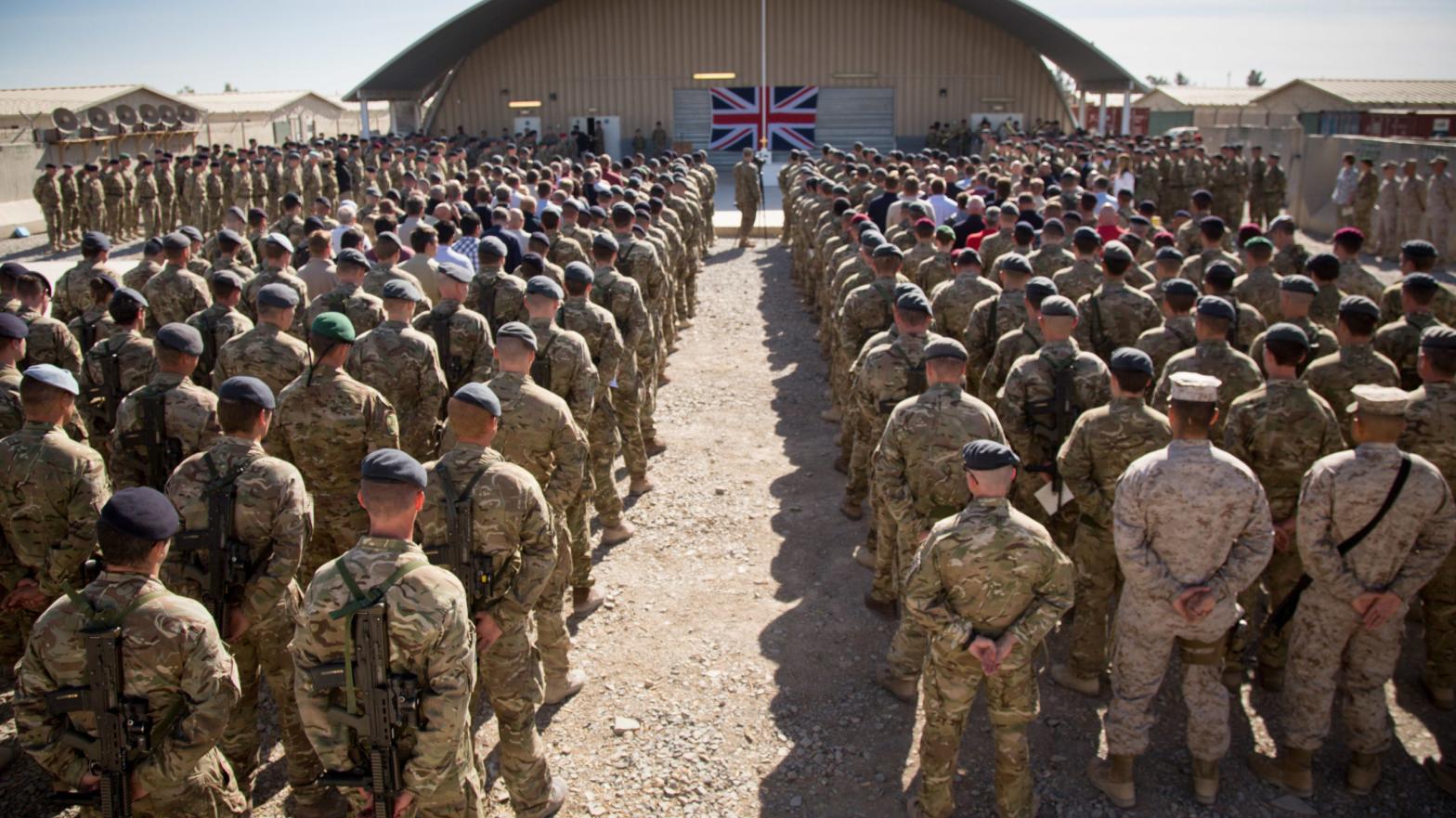 British troops and service personal remaining in Afghanistan are joined by International Security Assistance Force (ISAF) personnel and civilians as they gather for a Remembrance Sunday service at Kandahar Airfield November 9, 2014 in Kandahar, Afghanistan. (Photo: Matt Cardy, Getty Images)