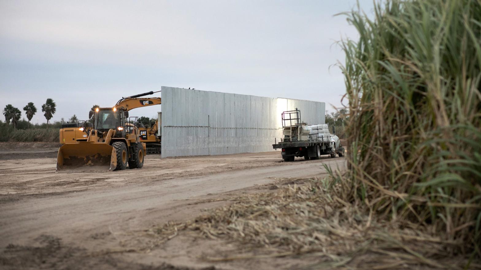 A loader grades land near a section of privately-built border wall under construction on December 11, 2019 near Mission, Texas.  (Photo: John Moore, Getty Images)